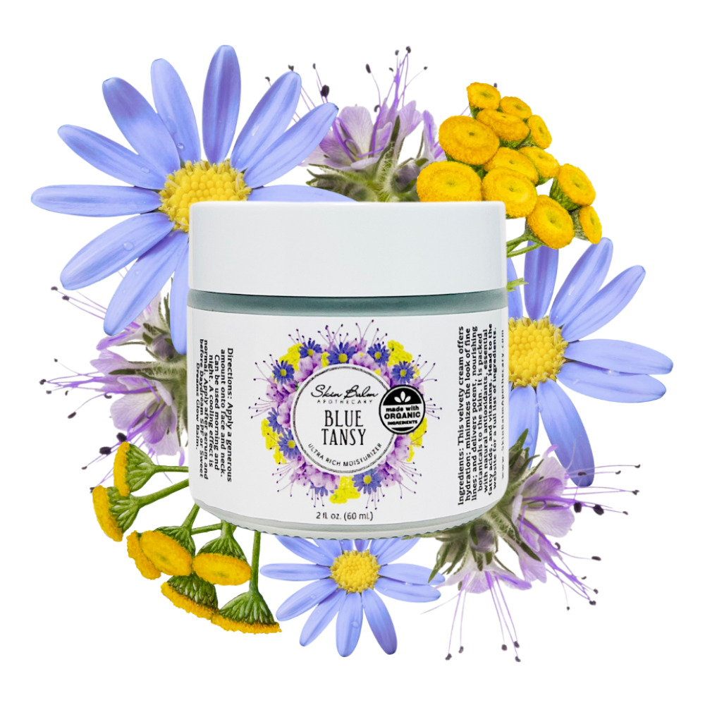 Blue Tansy Ultra Rich Moisturizer with assorted blue, yellow, and violet flowers against a white background.